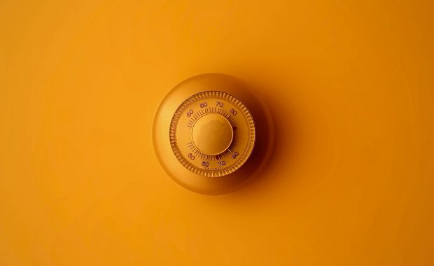 Dial thermostat on orange background