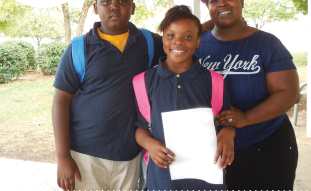 Smiling family with children in school uniforms wearing backpacks in a frame promoting Shop for Good week